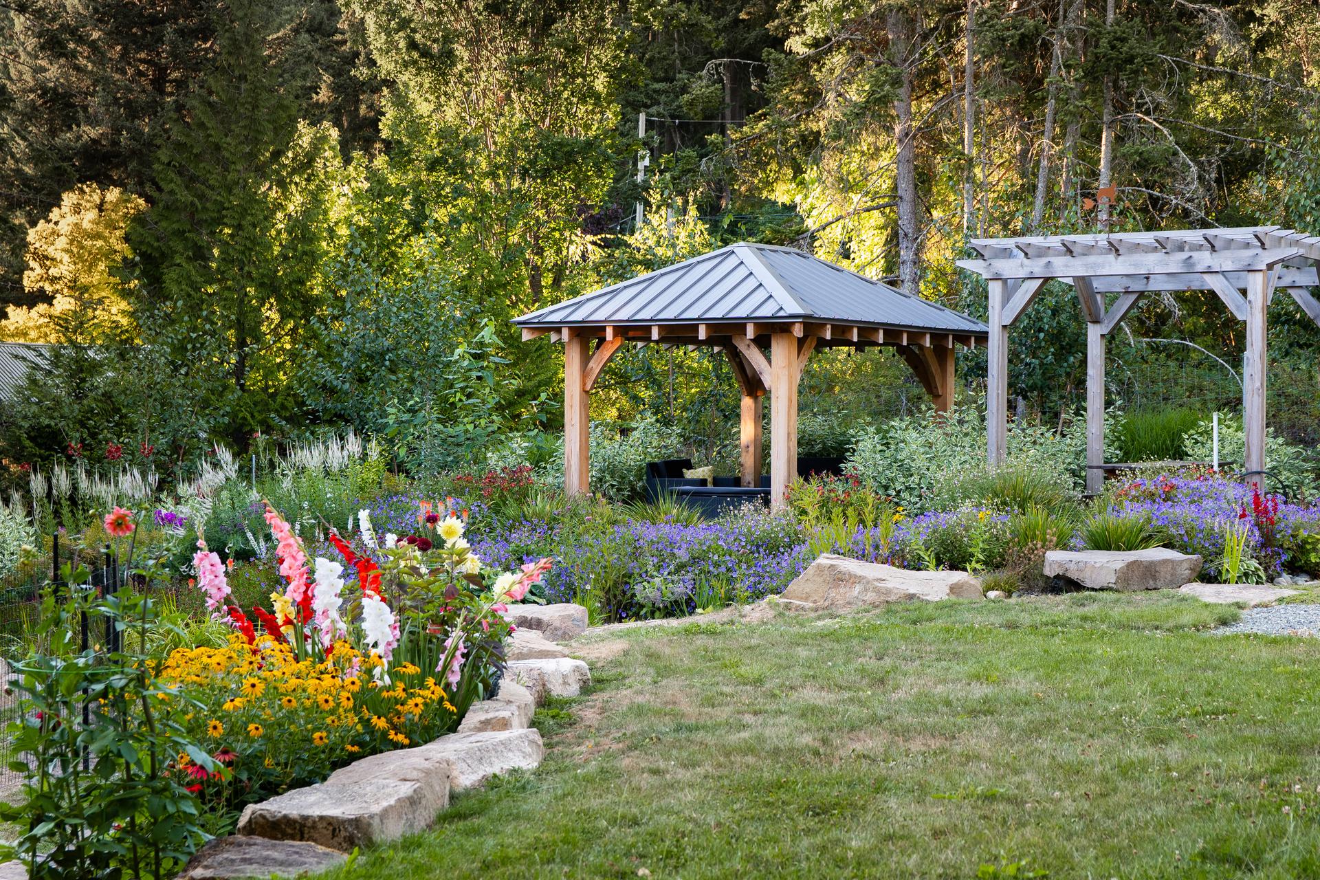 Gazebo and pergola behind perennial borders